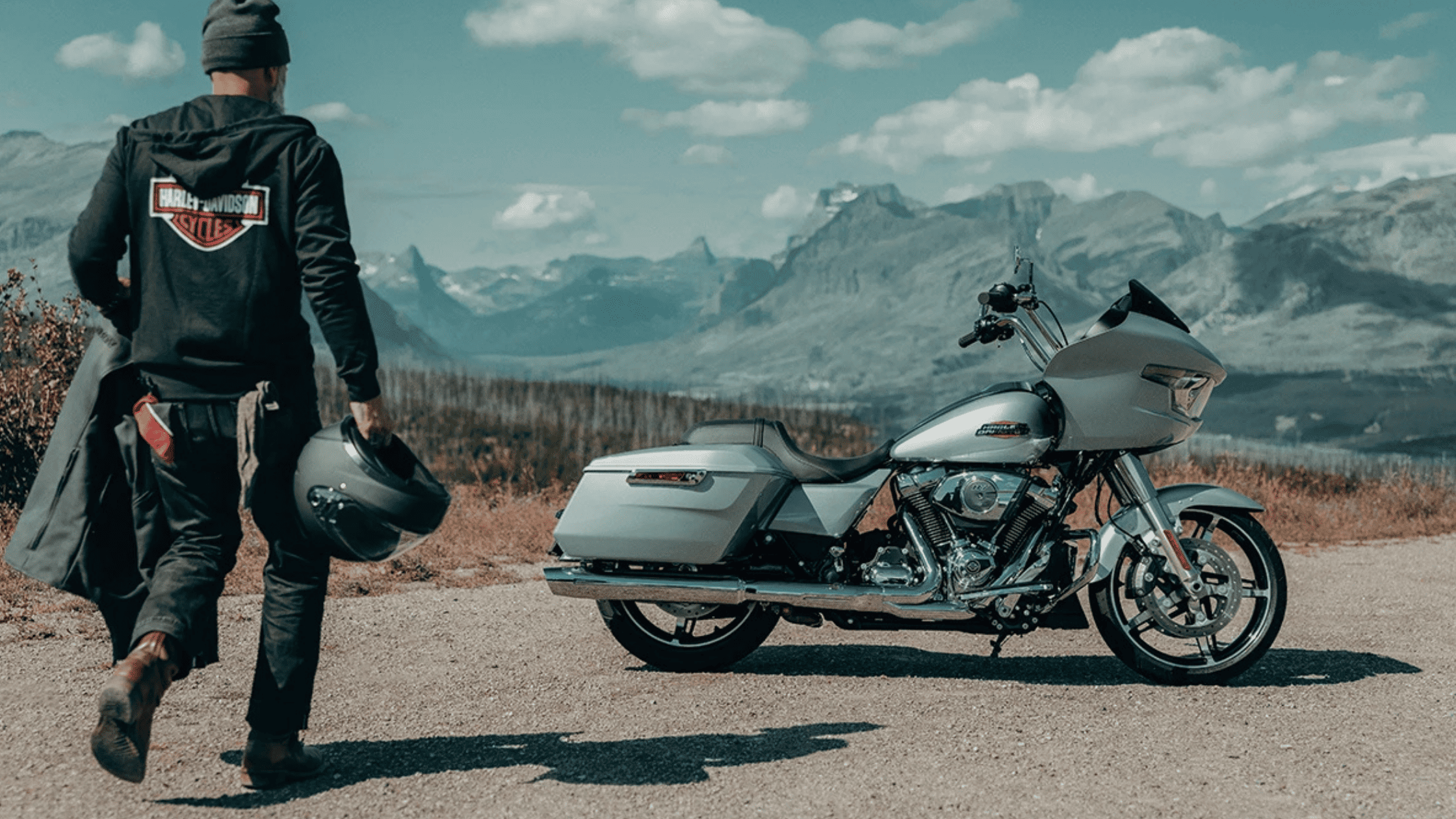 2025 Harley-Davidson® Road Glide parked against a breathtaking mountain backdrop, featuring a sleek aerodynamic fairing, powerful Milwaukee-Eight® engine, and premium saddlebags for long-distance comfort and performance