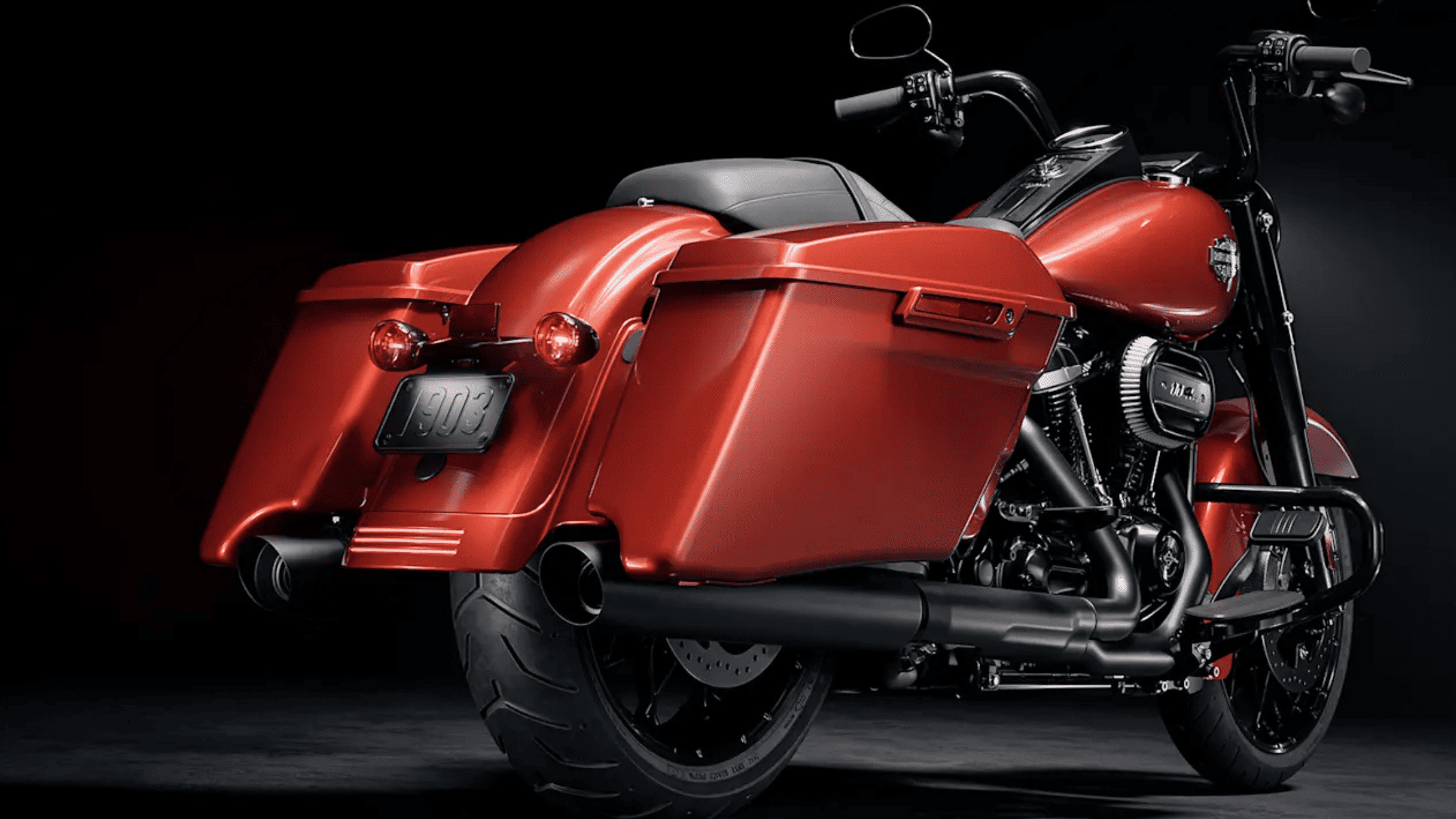 . A striking red 2025 Harley-Davidson® Road King Special motorcycle displayed against a sleek black…